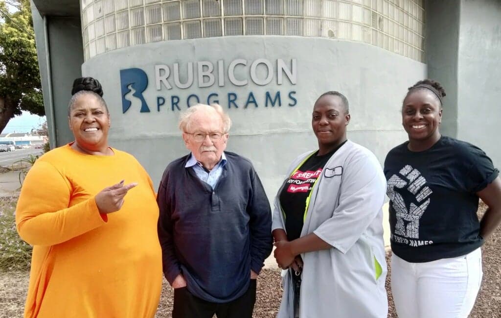 Rubicon's Participant Advisory Board Chairperson Gail Thomas, Rotary Club of Richmond's Housing First Coordinator Tom Herriman, Rubicon participant and housing recipient Amara James, and Rubicon's Community Connections Program Manager Alisha Semplar